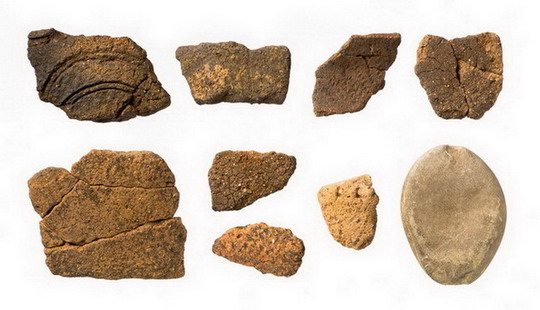 出土した縄文土器と石錘